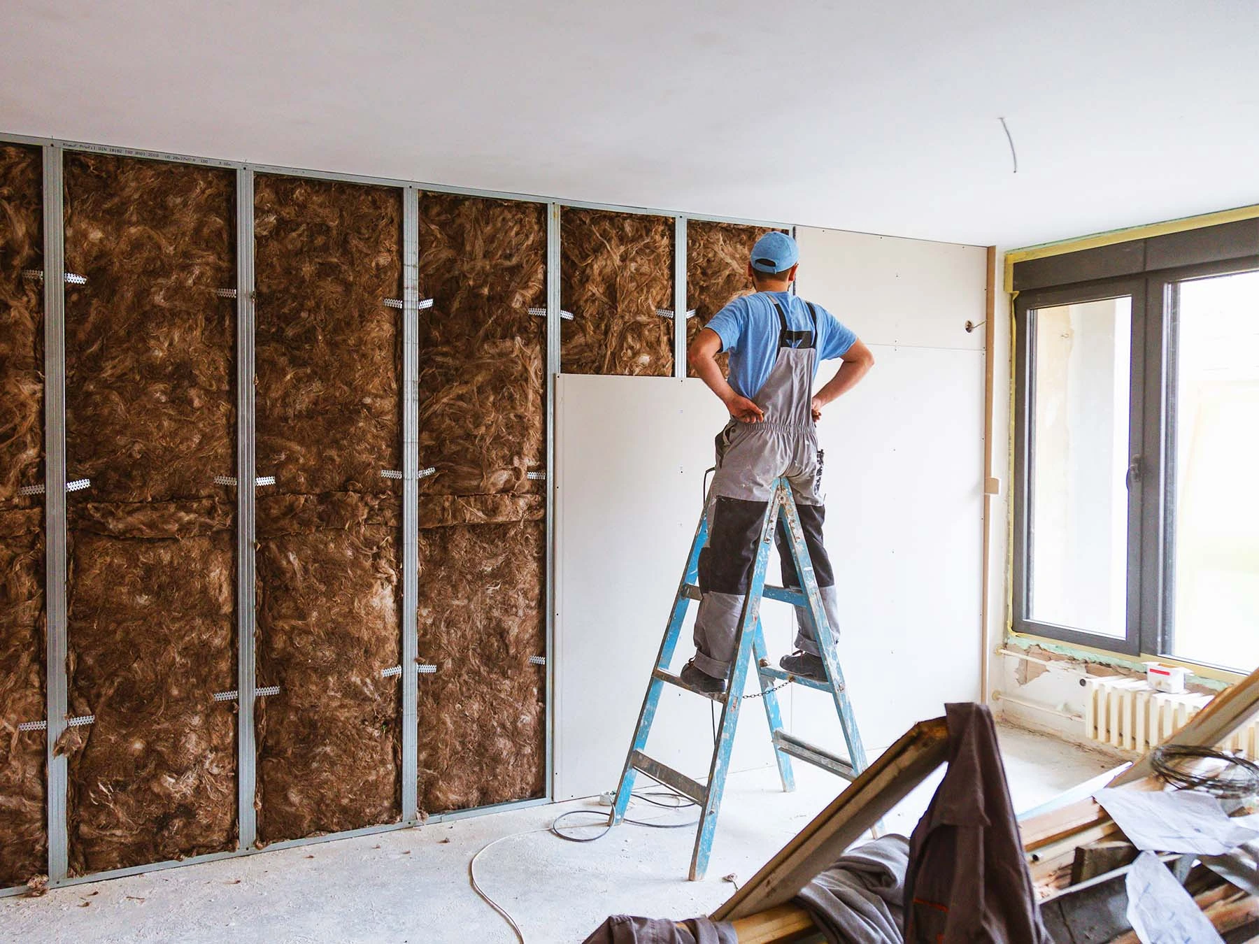 Worker installing drywall hero